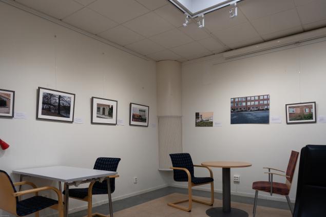 Ett hörn av utställningen Där vi en gång var på Alviks bibliotek. Stolar, bord och på bilderna inramade fotografier.